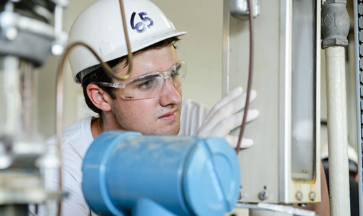 Male in hard hat in factory